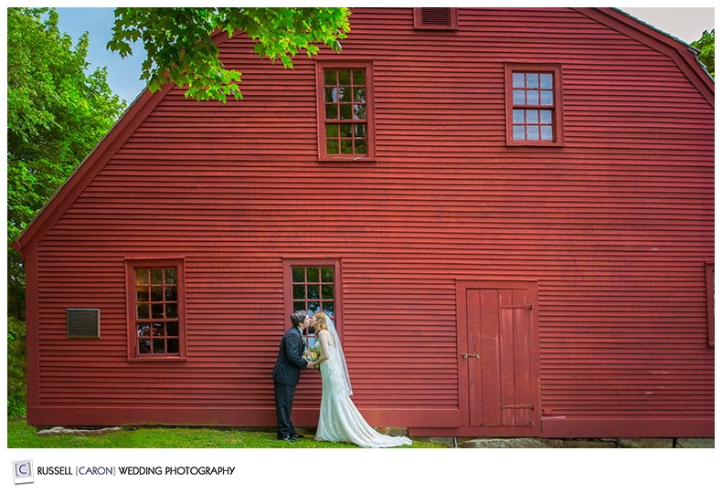 Bride and groom in front of red house in York Harbor