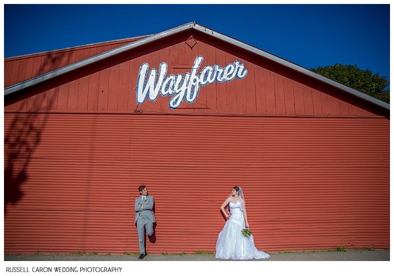 Bride and groom in front of Wayfarer Marine, Camden Maine