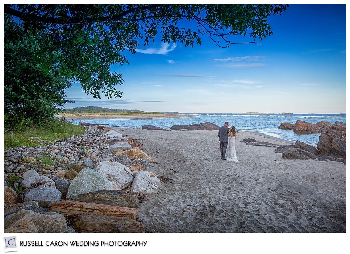 Bride and groom walking on beach