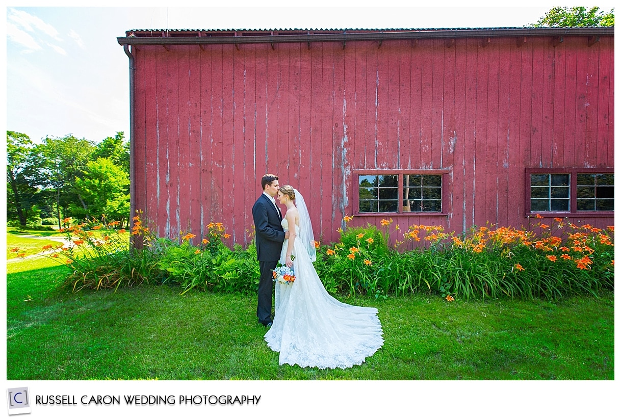 New England wedding photography with bride and groom in front of barn