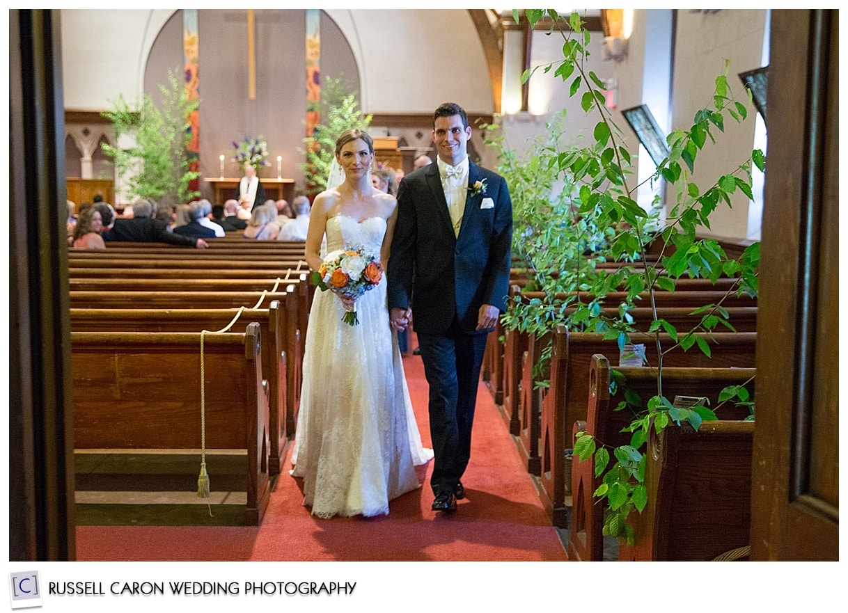 Bride and groom coming down the aisle