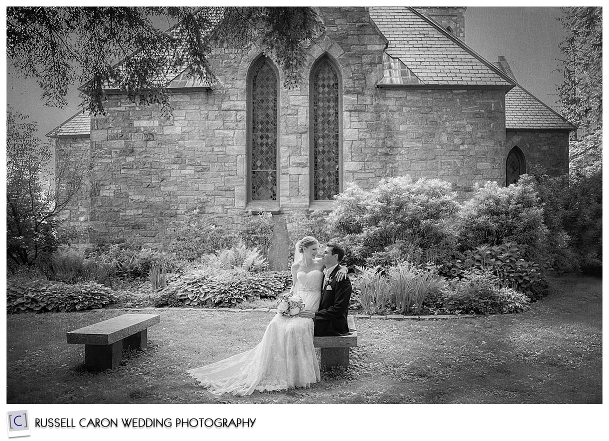 Bride and groom sitting outside the church