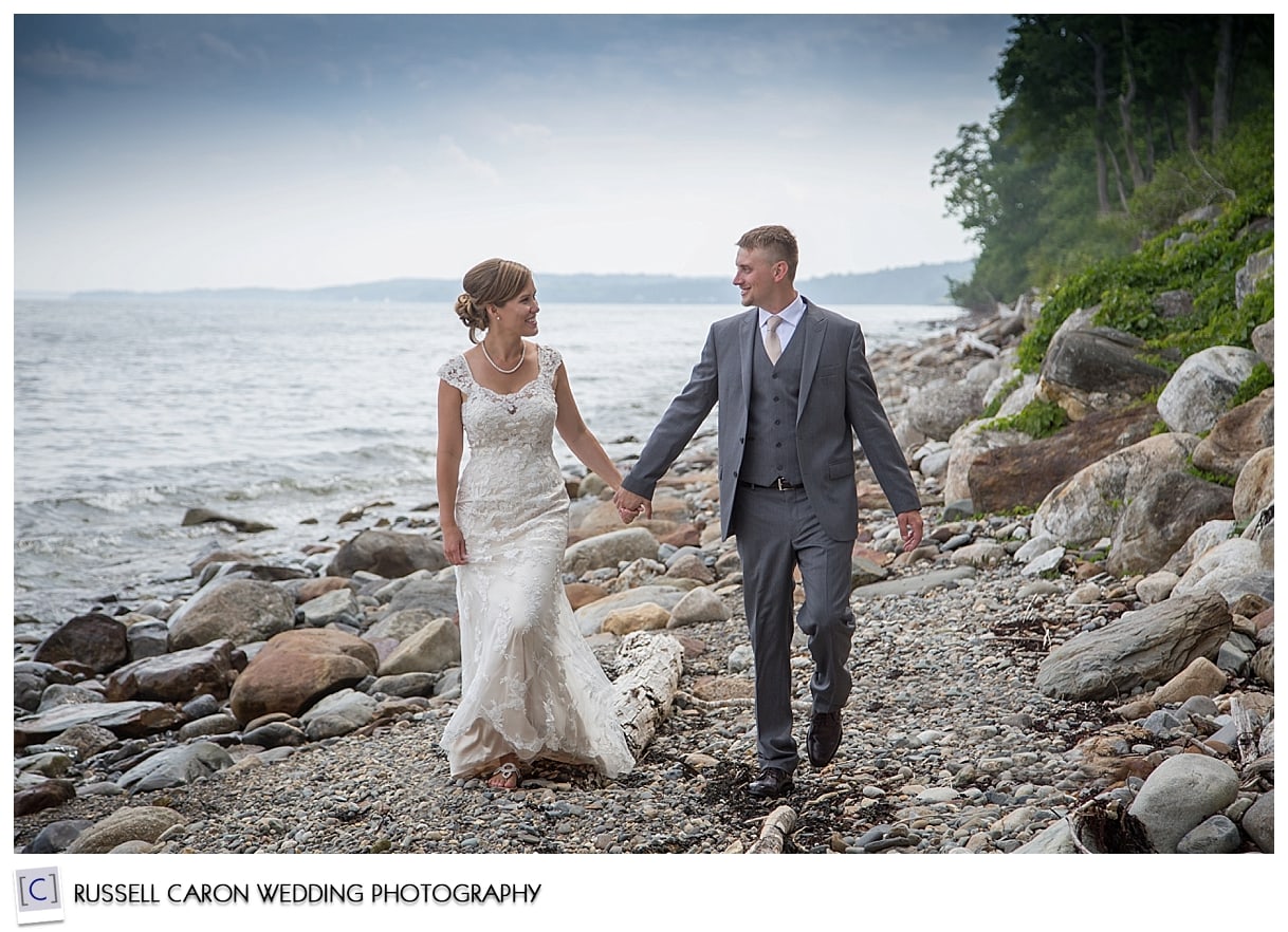 Bride and groom walking on the beach