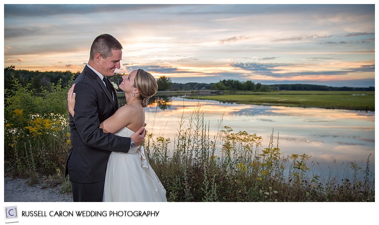 bride and groom by the water