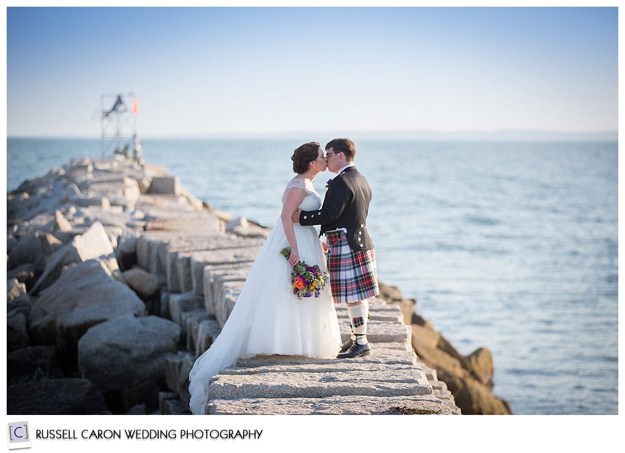 Bride and groom on breakwater