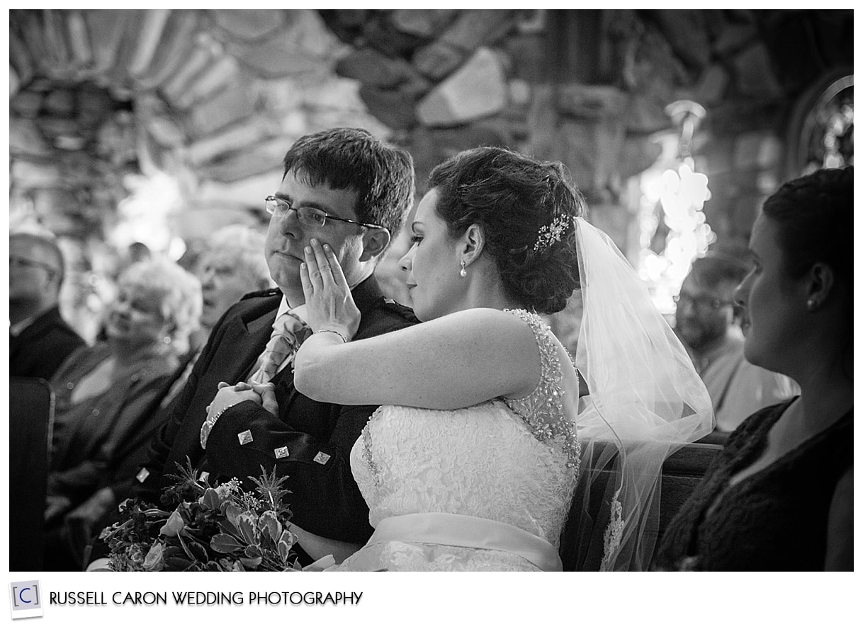 Bride wipes tear from groom