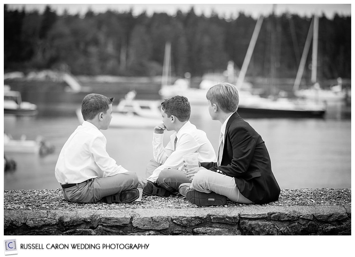 ring bearers and friend sitting on a wall