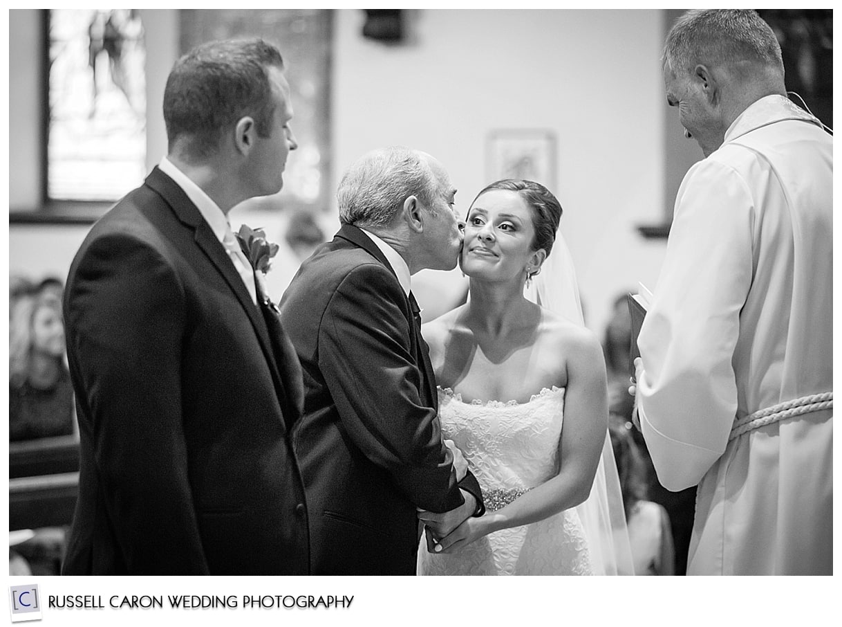 Father kissing bride's cheek