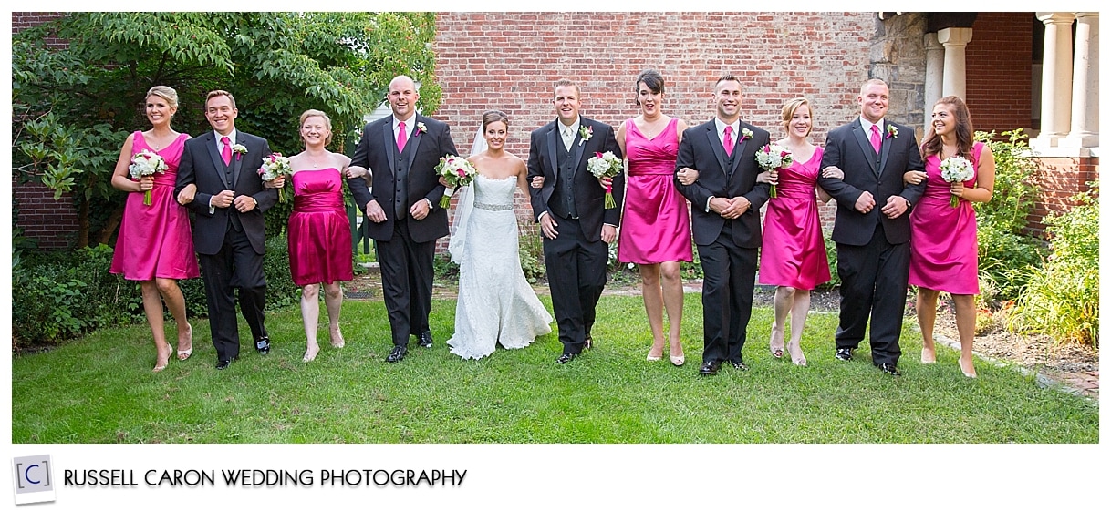 Bridal party walking toward photographer