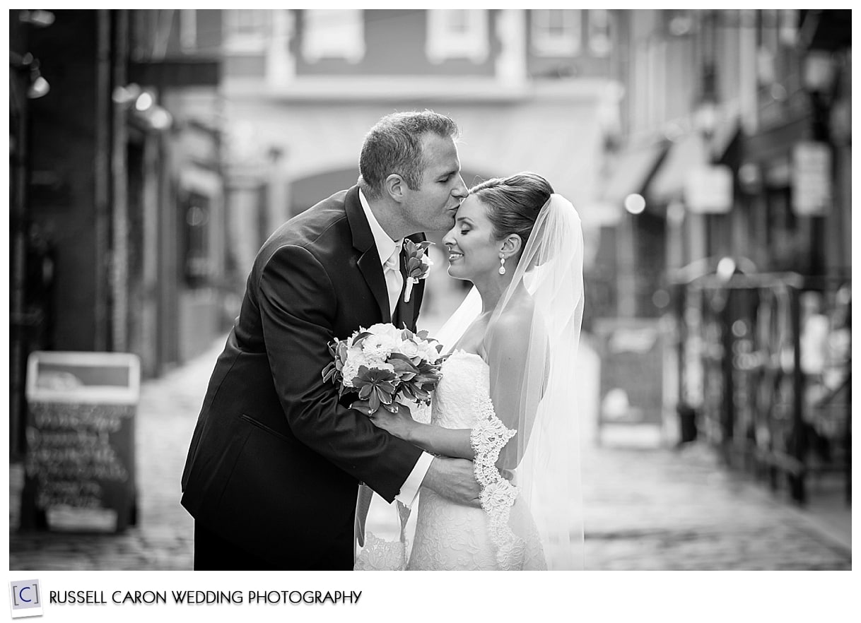 Bride and groom kissing on Wharf St Portland Maine