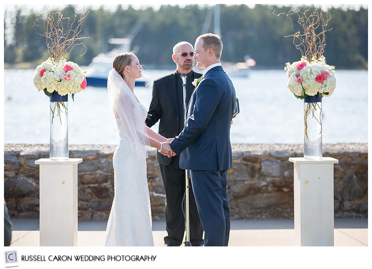 Bride and groom in front of officiant at wedding