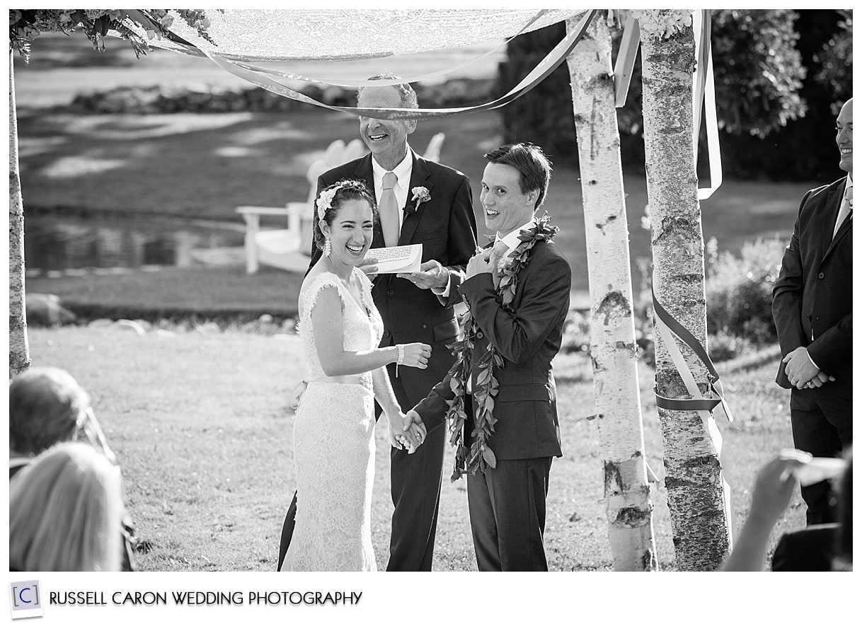 Bride and groom laughing during vows