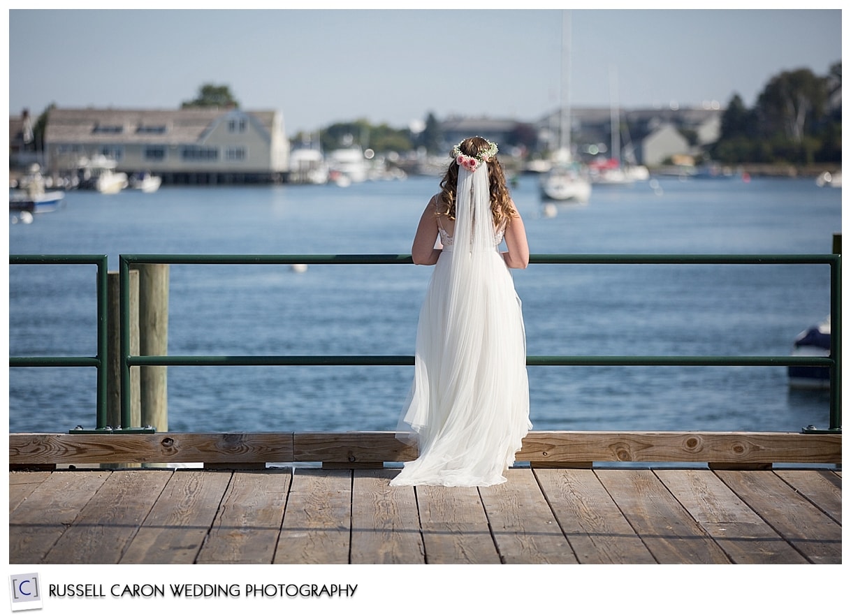 Bride standing on a dock in York Harbor Maine