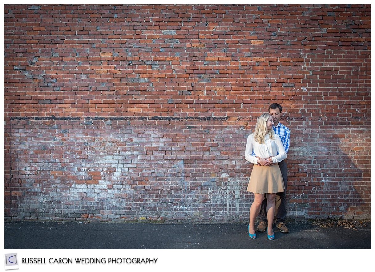Couple in front of a brick wall