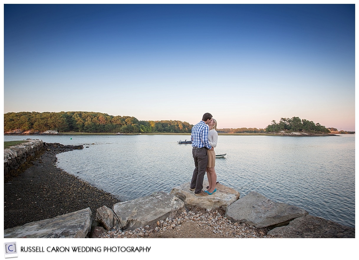 Couple kissing near the water