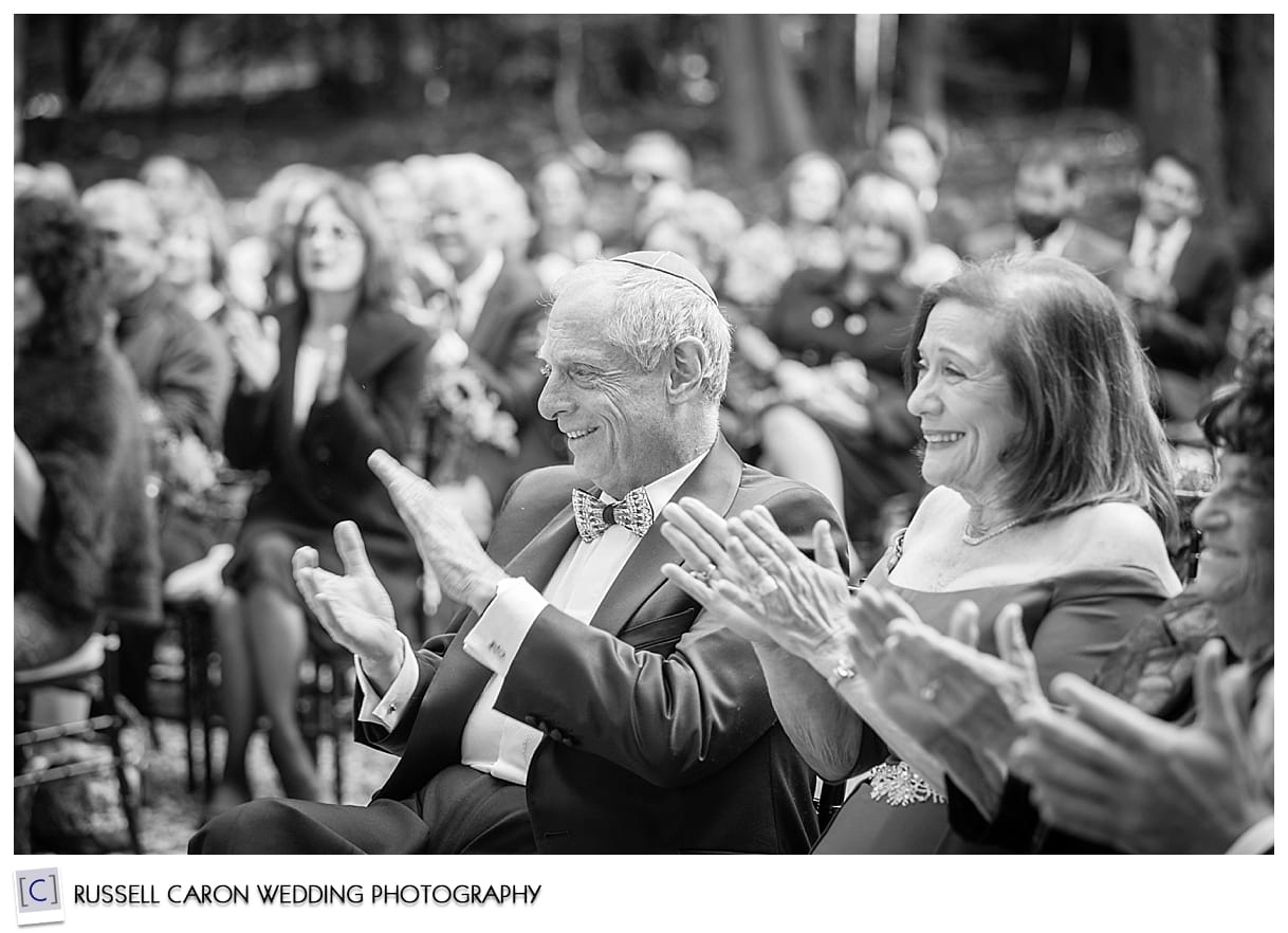 Mother and father of the bride applauding