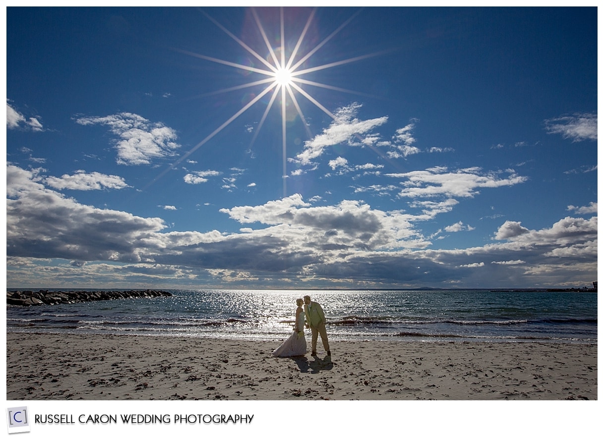 Bride and groom on the beach in Kennebunk Maine, by Kennebunkport Maine wedding photographers, Russell Caron Wedding Photography