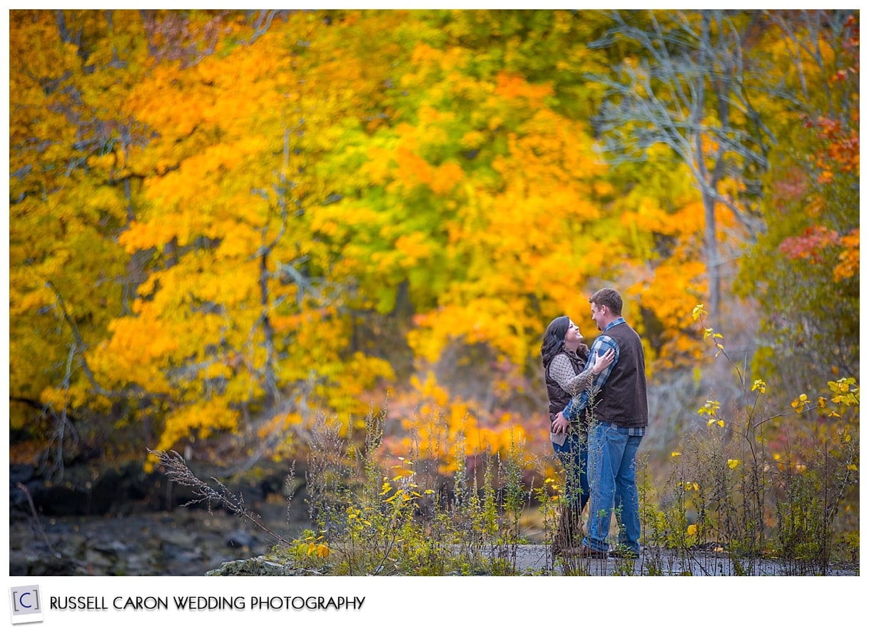 Engaged couple amid fall foliage