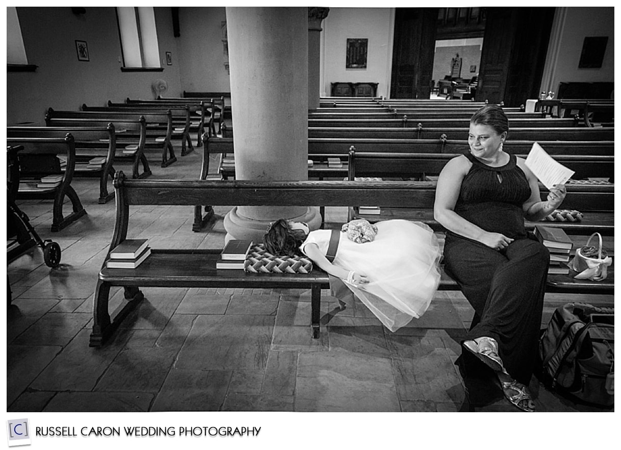 Flower girl asleep on church pew