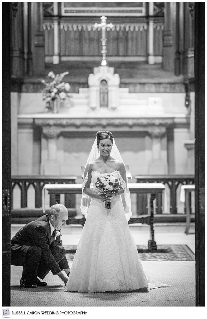 Father adjusting bride's gown