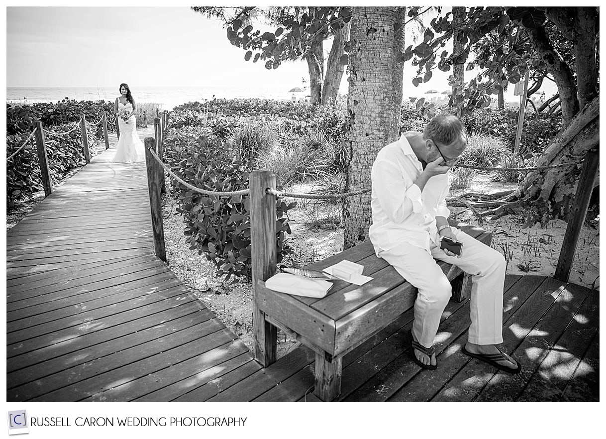 Bride watches groom, Casa Ybel, Sanibel Island, Florida