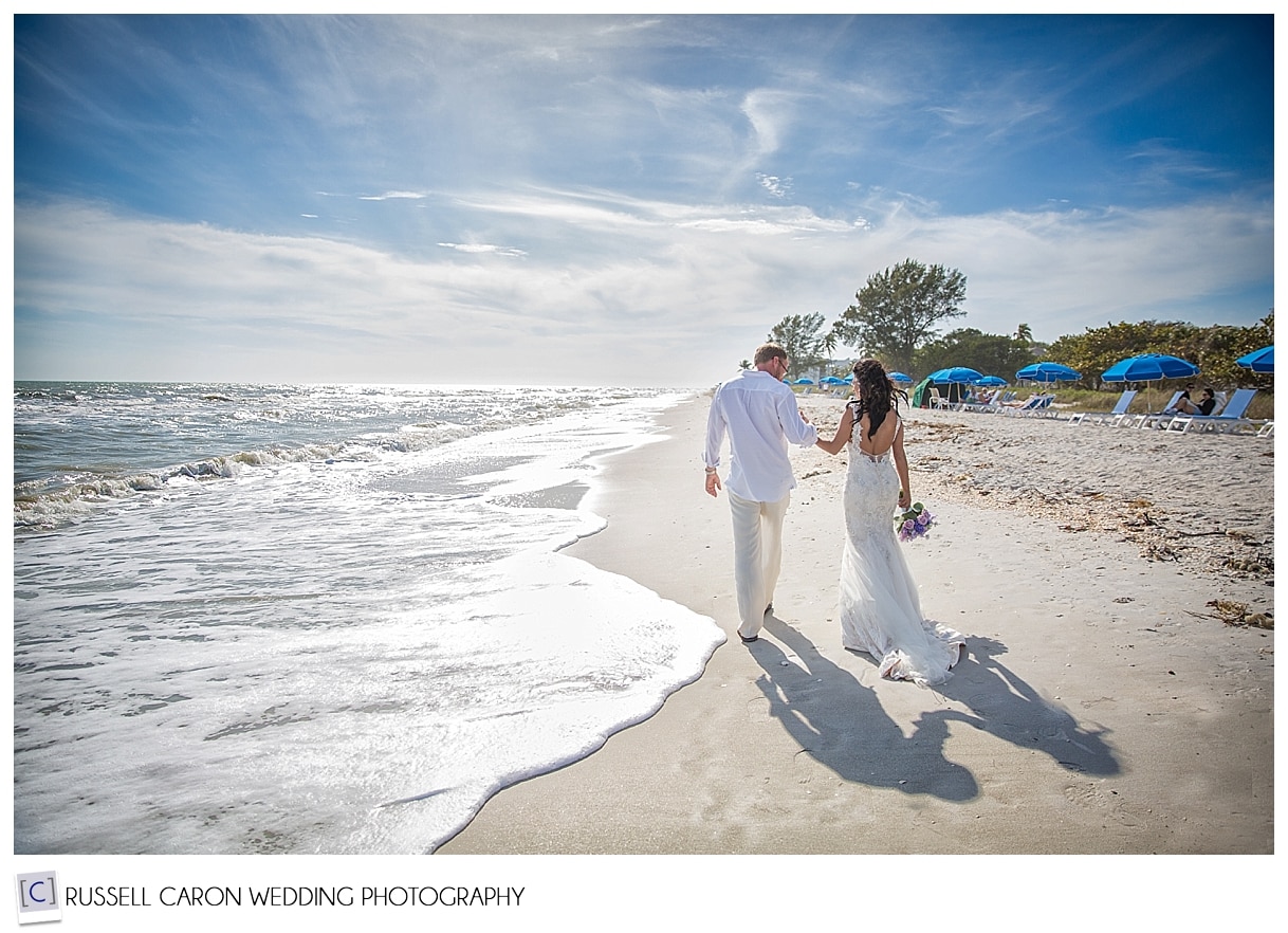 Bride and groom walking on Sanibel Island beach