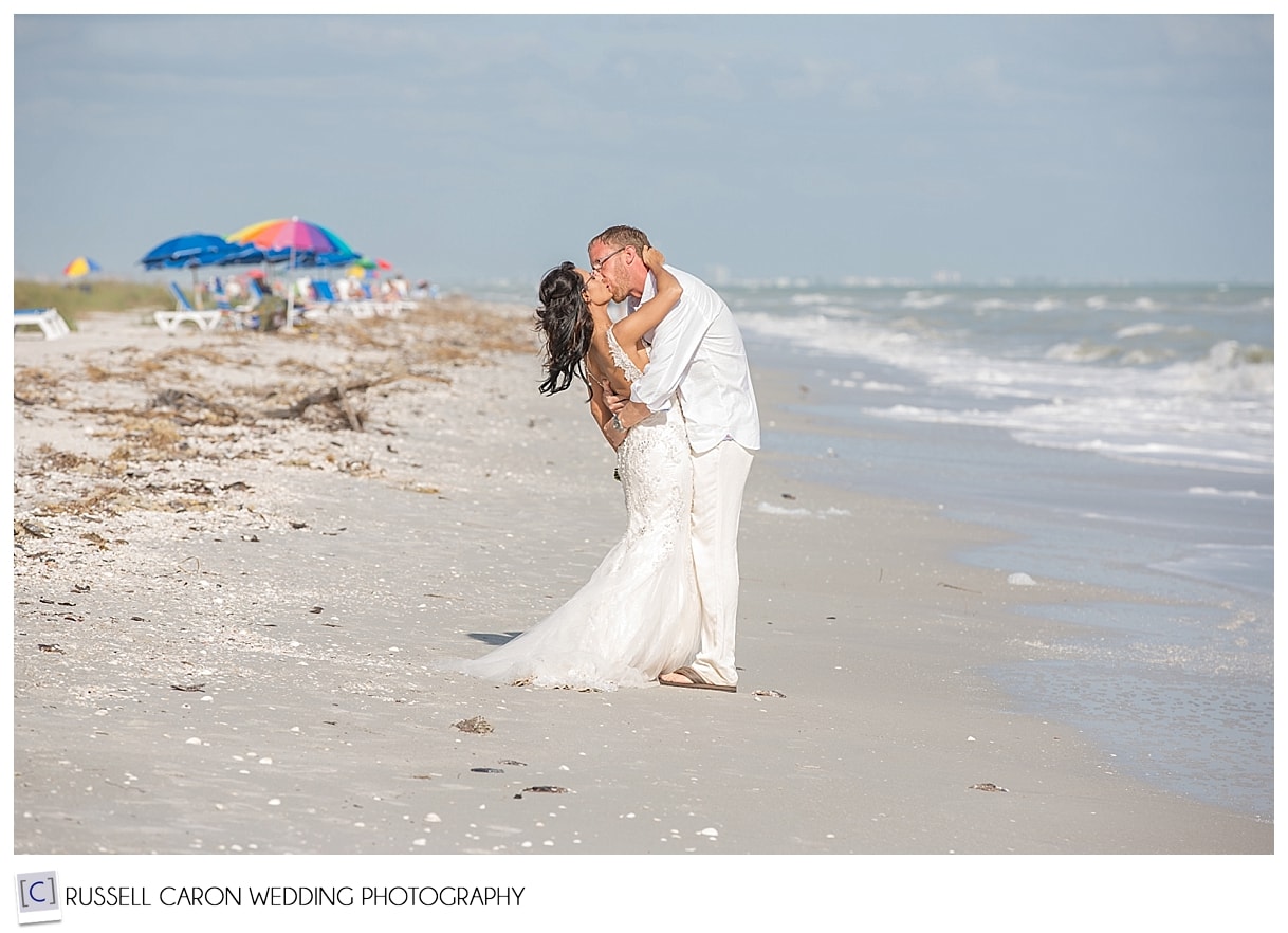 Bride and groom kissing on Sanibel Island beach, Florida