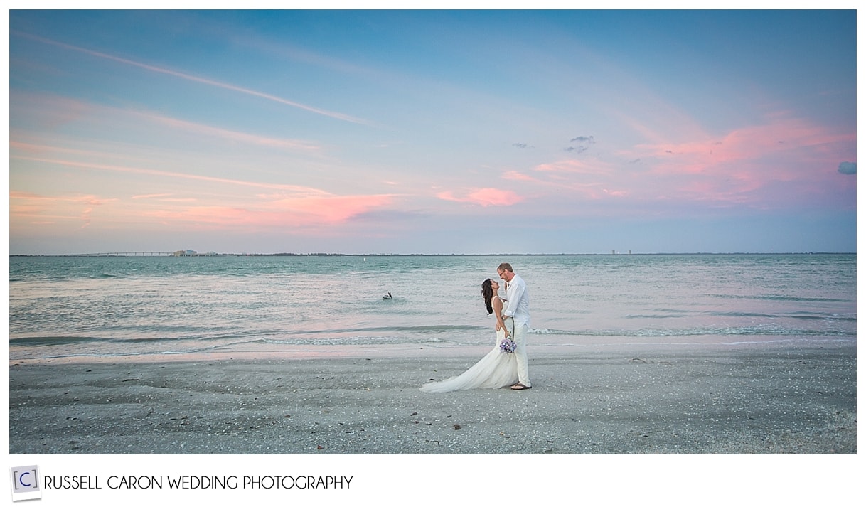 Bride and groom at sunset on Sanibel Island beach,