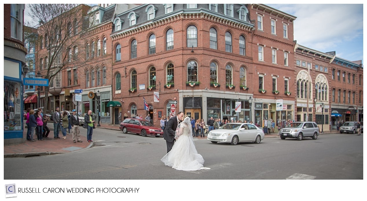 Bride and groom kissing in the middle of Fore Street, Portland Maine