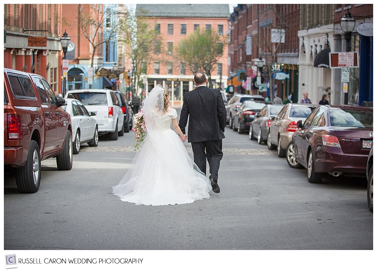 Bride and groom walking down Exchange Street, Portland Maine