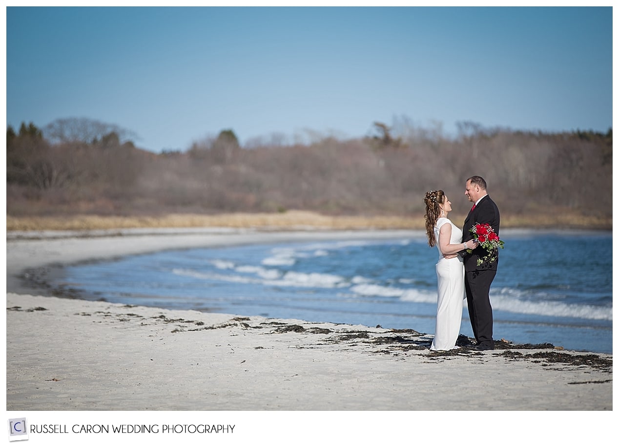 Bride and groom by the water's edge