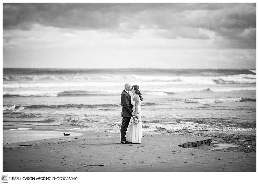 wedding couple in a romantic black and white  image at the ocean