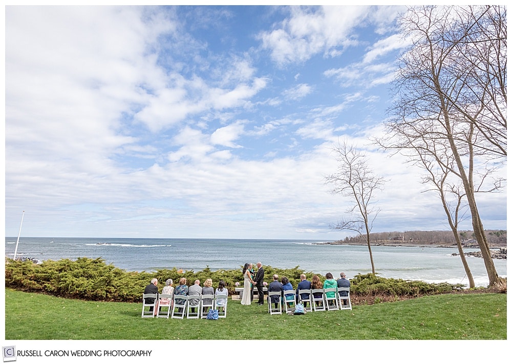 wide view of small wedding ceremony near shore