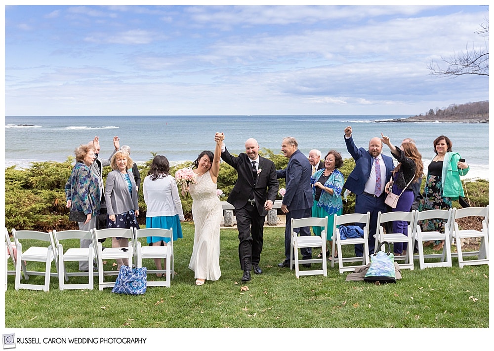 couple just married recessional from outdoor wedding