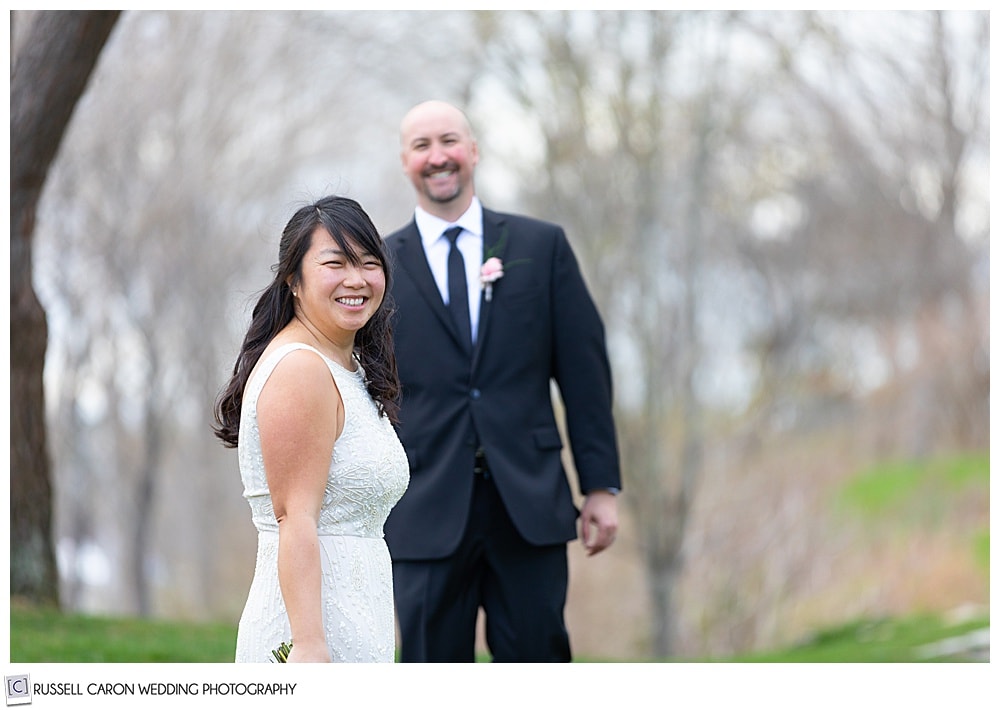 bride with groom in background