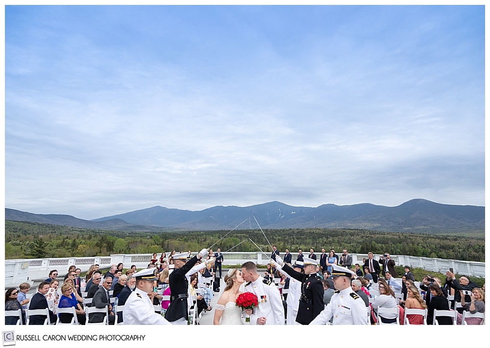 Bride and groom during a military wedding Sword Arch