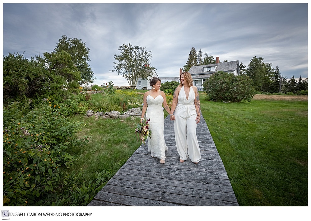 two Burnt island brides walking the boardwalk during sunset, Boothbay Harbor, Maine