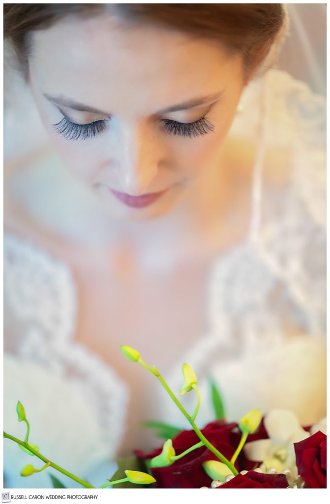 Gorgeous bridal portrait of a bride looking down at her bouquet