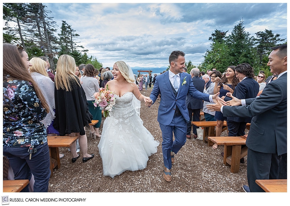 overjoyed wedding recessional image of a bride and groom at Mount Sunapee