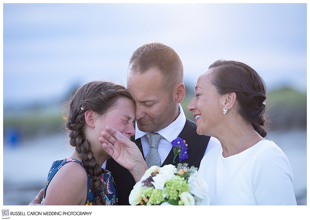 poignant family wedding moment of father, daughter and mother