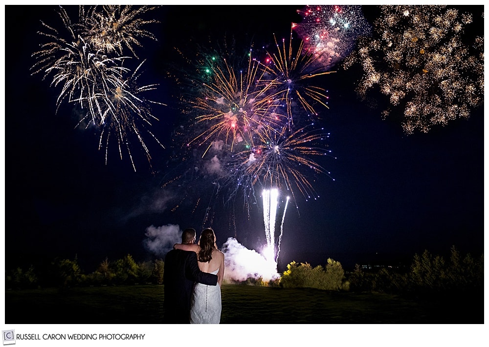 Bride and groom watching their spectacular wedding fireworks at Point Lookout, Northport, Maine. Maine wedding day fireworks photo