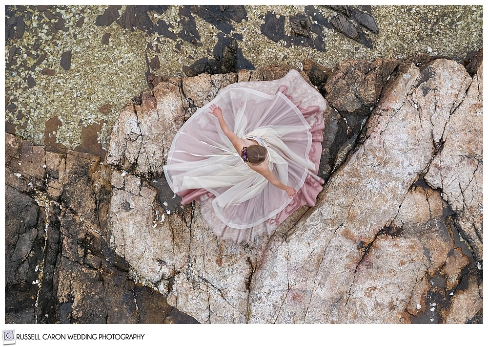 twirling bride drone photo of a bride on the shore of Harpswell, Maine