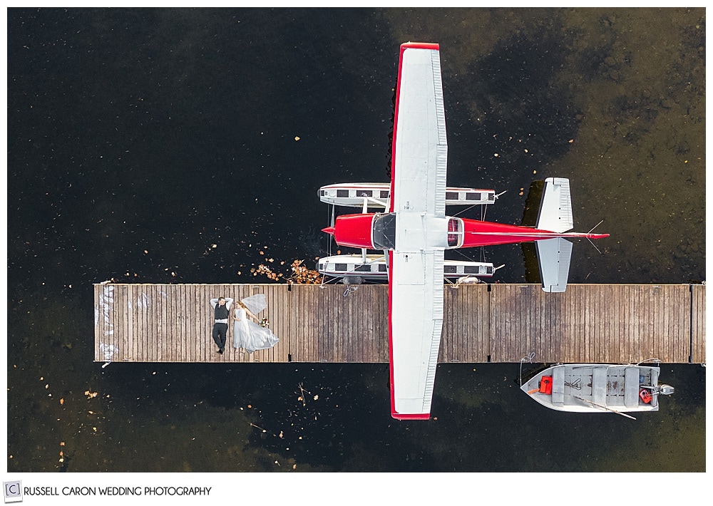 Bride and groom in seaplane drone photo at a lakeside Maine wedding, Naples, Maine