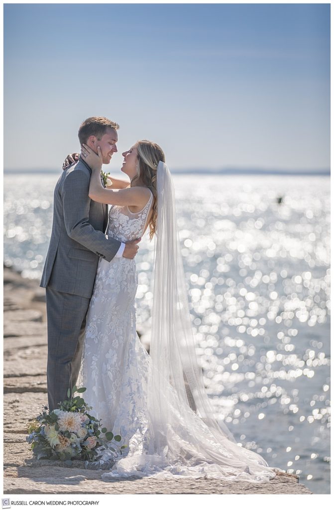 Elated bride and groom on the Kennebunkport Breakwater