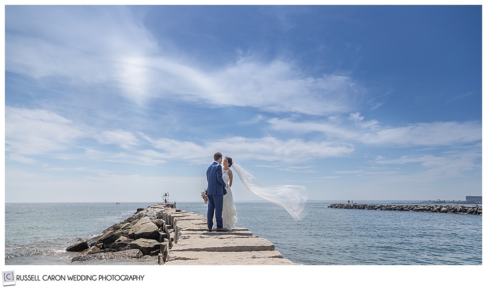 Breezy breakwater photo of bride's veil blowing in the wind at the Kennebunkport Breakwater, Kennebunkport, Mzine