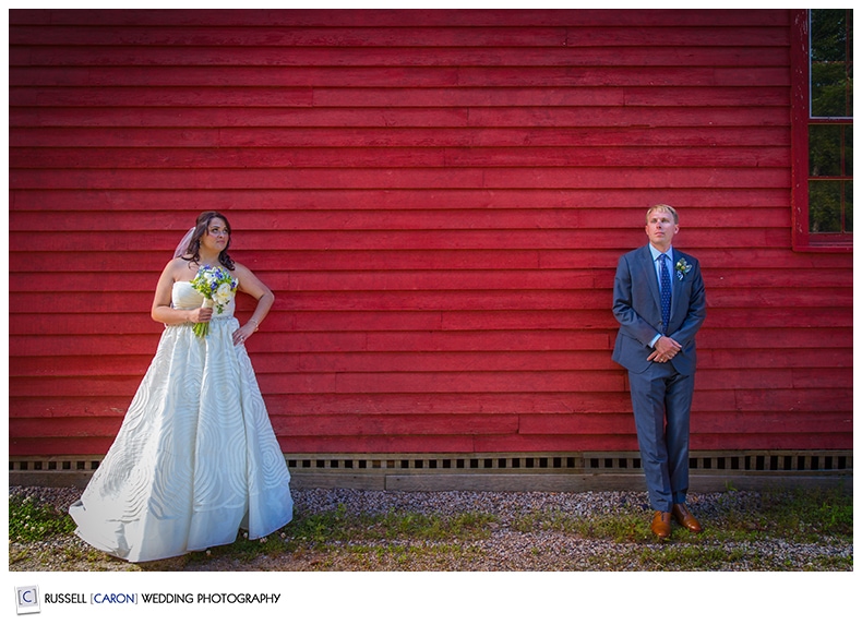 Bride and groom in front of a red wall, Kennebunkport, Maine