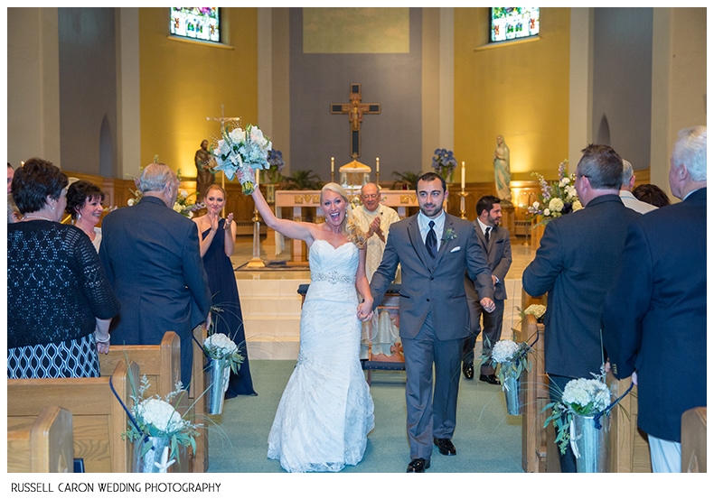 Bride and groom during recessional at St. Joe's, Biddeford, Maine