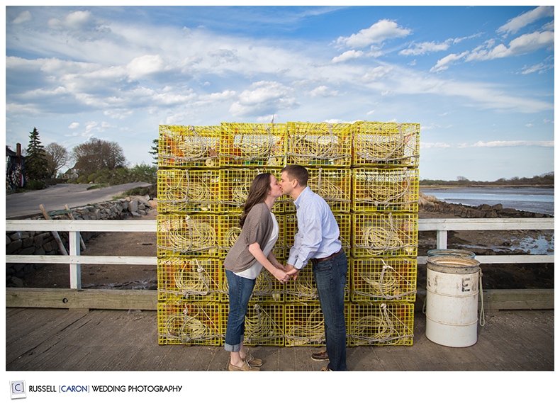 A couple kissing in front of lobster traps, Kennebunkport Maine