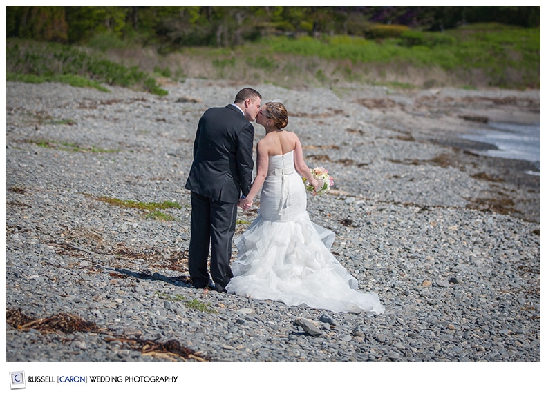 Bride and groom walking on the beach in Kennebunkport, Maine