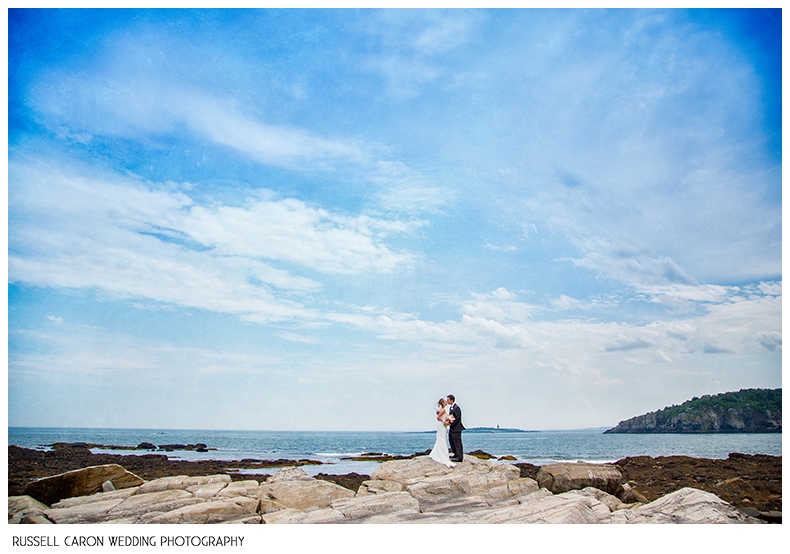 Bride and groom on the rocks at Peaks Island maine